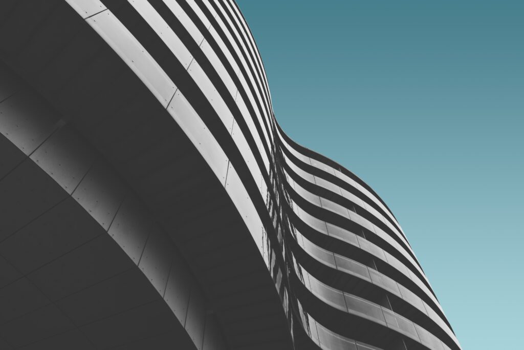 Low angle shot of a grey concrete building under the blue sky